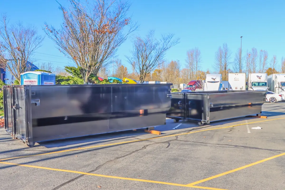 Professional dumpster rental service with roll-off container on residential driveway in Groveport